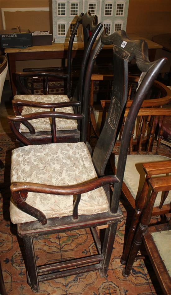 A pair of Chinese elm arm chairs,